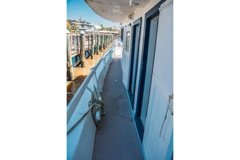 Slide: The Image of Side deck of 1977 Saint Augustine 43 Trawler docked at marina. - 54