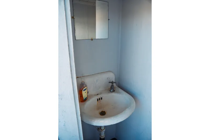 Slide: The Image of Small bathroom sink with mirror on a 1977 Saint Augustine 43 Trawler boat. - 57