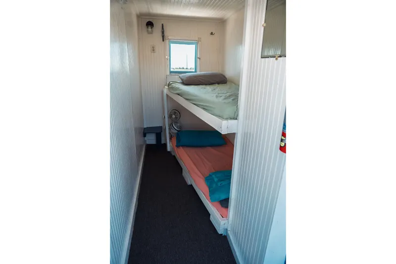 Slide: The Image of 1977 Saint Augustine Trawler 43 interior with bunk beds and window view. - 58
