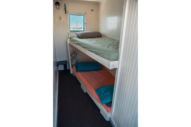 Slide: The Image of 1977 Saint Augustine Trawler 43 interior with bunk beds and window view. - 59