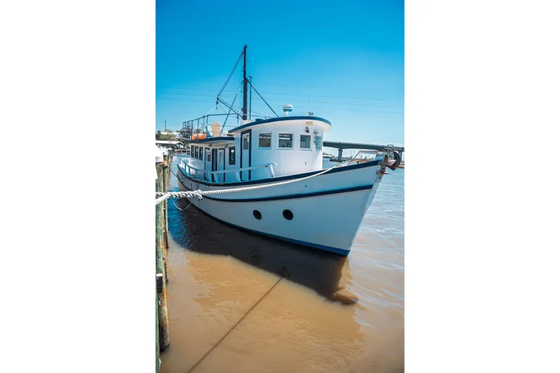 Slide: The Image of 1977 Saint Augustine 43 Trawler docked on a sunny day, showcasing classic nautical design. - 6