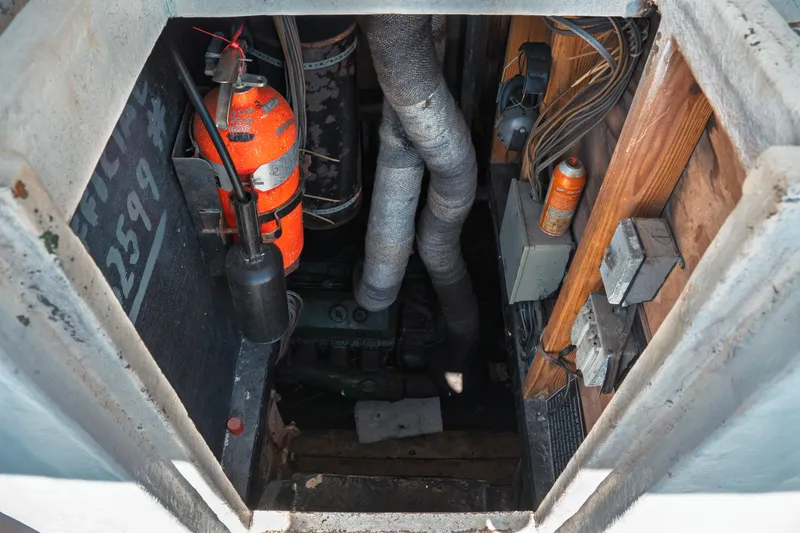 Slide: The Image of Engine room of a 1977 Saint Augustine 43 Trawler with fire extinguisher and wiring. - 60