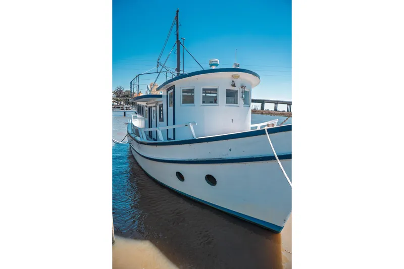 Slide: The Image of 1977 Saint Augustine 43 Trawler docked, showcasing classic design and white hull. - 8