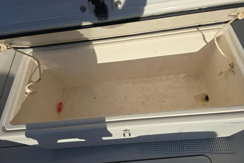 Slide: The Image of Open storage compartment on 2012 Fountain 38 CC Tournament Edition boat. - 17