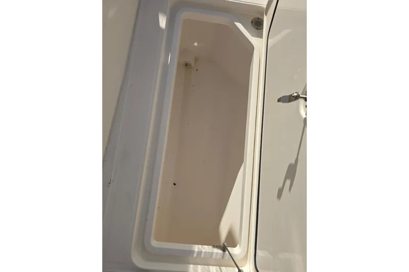Slide: The Image of Open storage compartment on 2012 Fountain 38 CC Tournament Edition boat. - 22