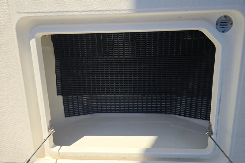 Slide: The Image of Open storage compartment on 2012 Fountain 38 CC Tournament Edition boat. - 25