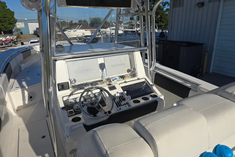 Slide: The Image of 2012 Fountain 38 CC Tournament Edition boat cockpit with Garmin navigation system and steering wheel. - 34