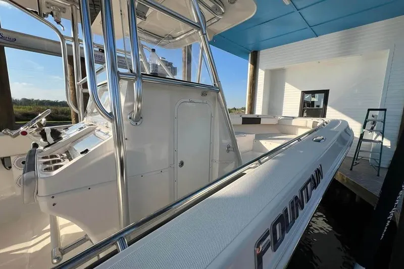 Slide: The Image of 2012 Fountain 38 CC Tournament Edition boat docked, showcasing sleek design and spacious deck. - 35