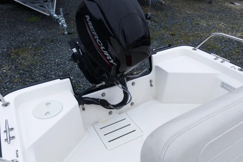 Slide: The Image of 2021 Boston Whaler 150 Montauk boat with Mercury outboard motor, rear view. - 13
