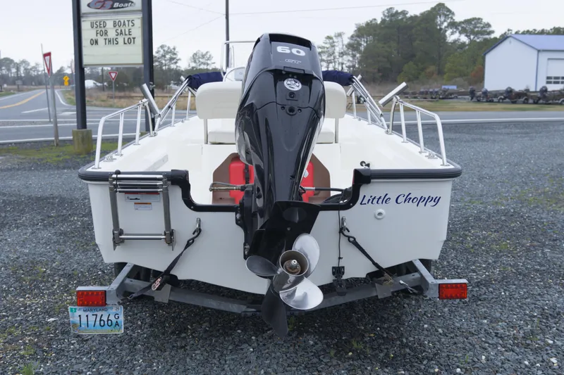 Slide: The Image of 2021 Boston Whaler 150 Montauk boat with outboard motor, named "Little Choppy," on a trailer. - 3
