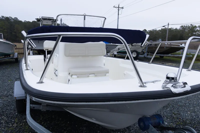 Slide: The Image of 2021 Boston Whaler 150 Montauk boat on trailer, parked outdoors. - 7