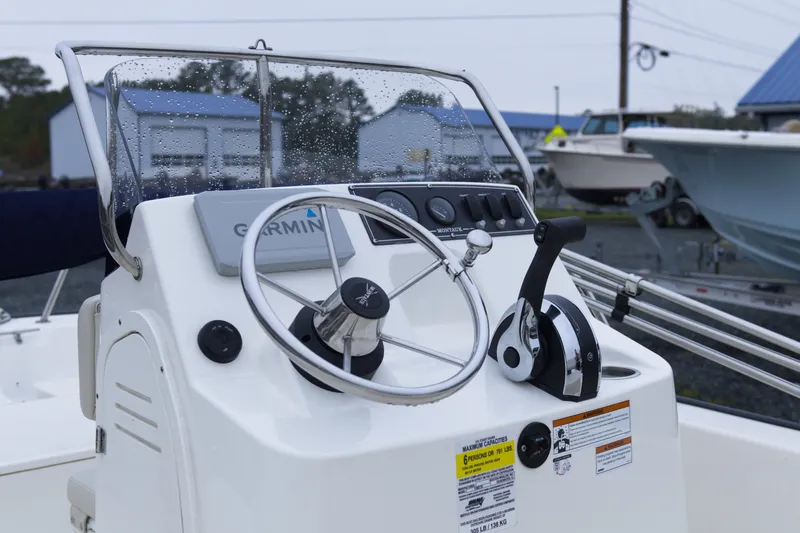 Slide: The Image of Steering console of a 2021 Boston Whaler 150 Montauk boat with Garmin equipment. - 8