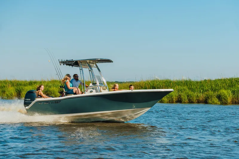 Slide: The Image of 2026 Key West 203 FS boat cruising on a sunny day with passengers onboard. - 12