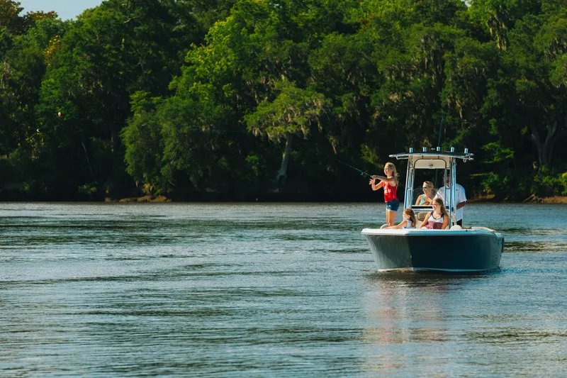 Slide: The Image of Family fishing on a 2026 Key West 203 FS boat in a scenic river. - 13