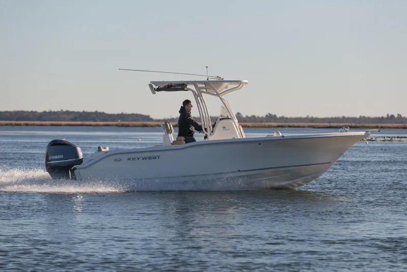 Slide: The Image of 2026 Key West 203 FS boat cruising on calm water with Yamaha engine. - 8