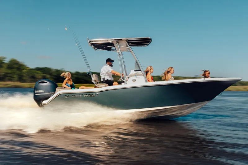 Slide: The Image of 2026 Key West 203 FS boat speeding on water with passengers enjoying the ride. - 9