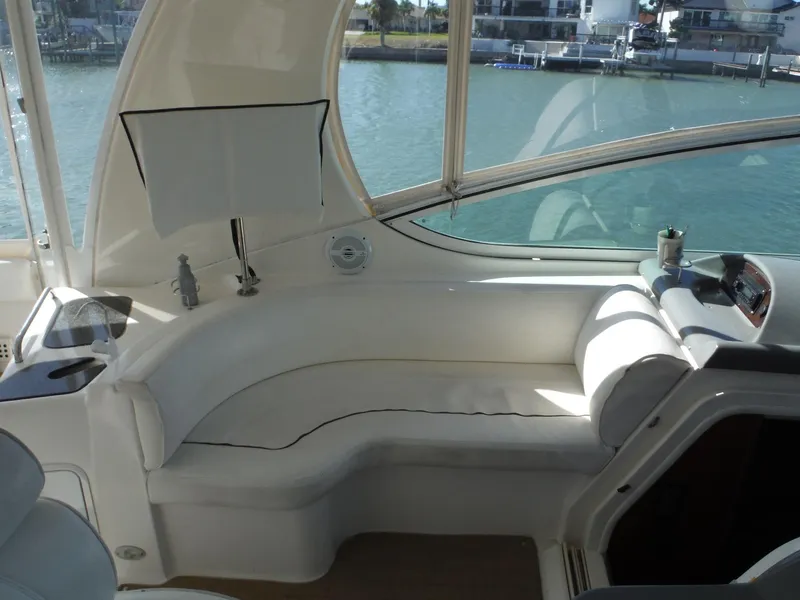 Slide: The Image of 2005 Cruisers Yachts 455 Express Motoryacht interior seating area with waterfront view. - 10