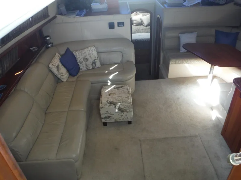 Slide: The Image of 2005 Cruisers Yachts 455 Express Motoryacht interior with beige leather seating and dining area. - 17