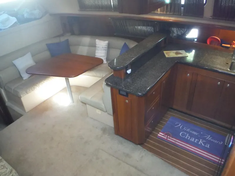 Slide: The Image of Interior of 2005 Cruisers Yachts 455 Express Motoryacht with dining area and kitchen. - 19