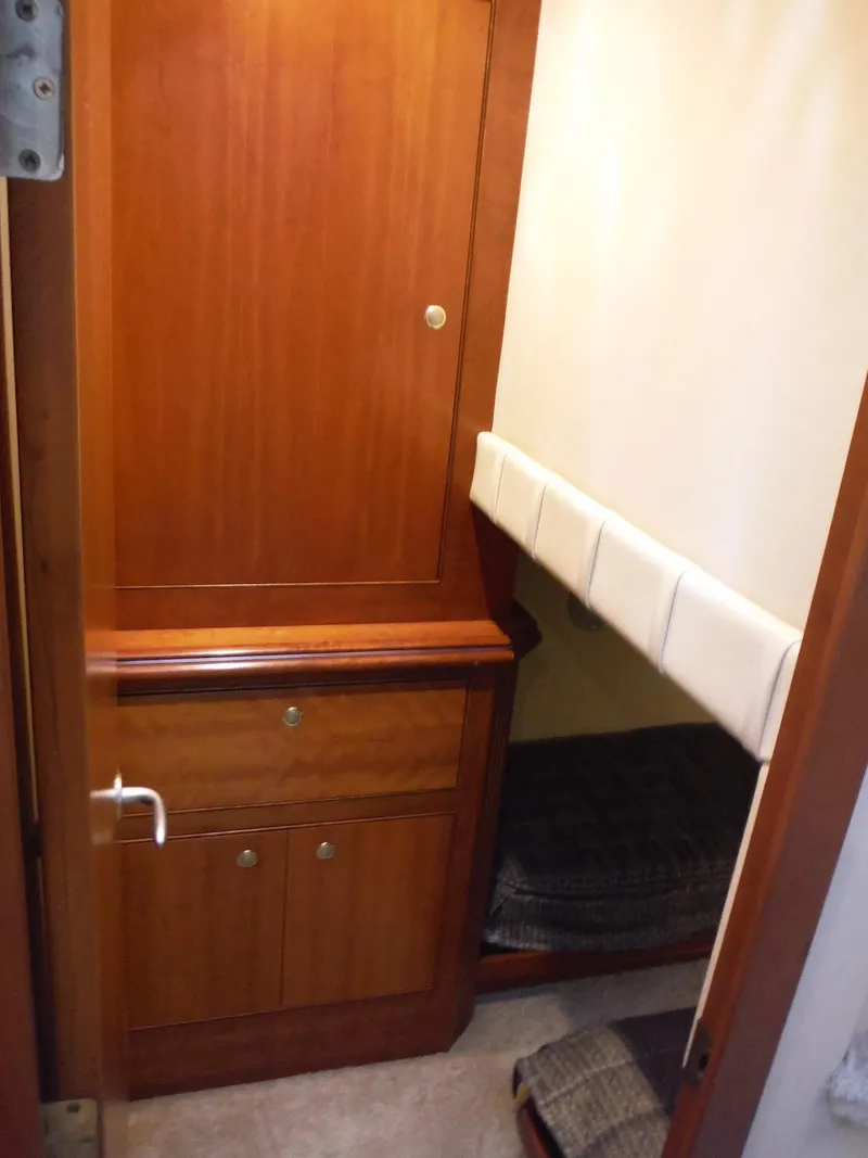 Slide: The Image of 2005 Cruisers Yachts 455 Express Motoryacht interior cabin with wooden cabinetry and bunk bed. - 28