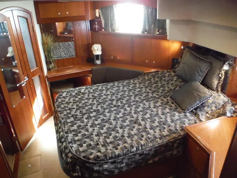 Slide: The Image of Luxurious bedroom interior of 2005 Cruisers Yachts 455 Express Motoryacht with elegant wood finishes. - 33
