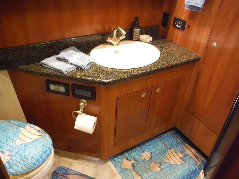 Slide: The Image of 2005 Cruisers Yachts 455 Express Motoryacht bathroom with granite countertop and nautical decor. - 36