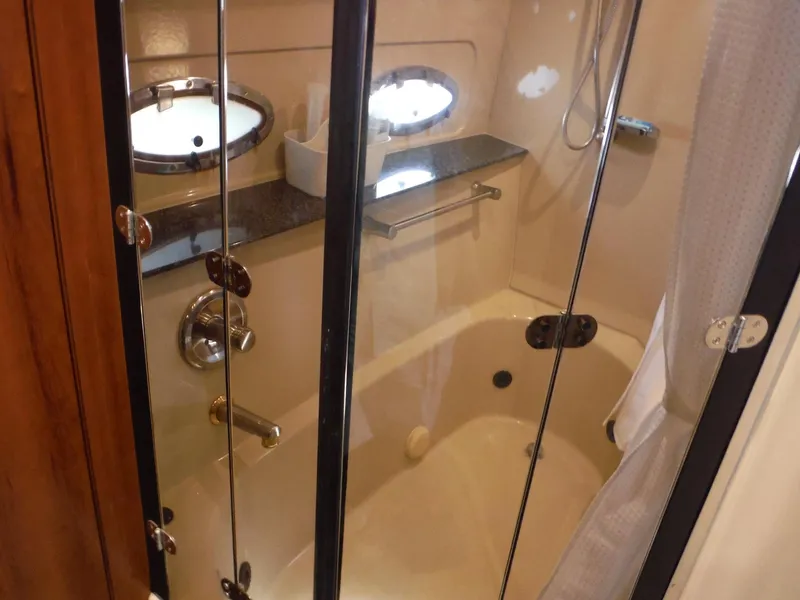Slide: The Image of 2005 Cruisers Yachts 455 Express Motoryacht bathroom with shower and tub. - 40