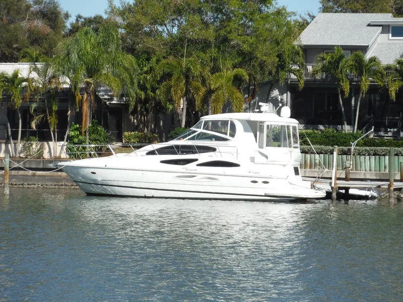 Slide: The Image of 2005 Cruisers Yachts 455 Express Motoryacht docked by waterfront homes. - 77