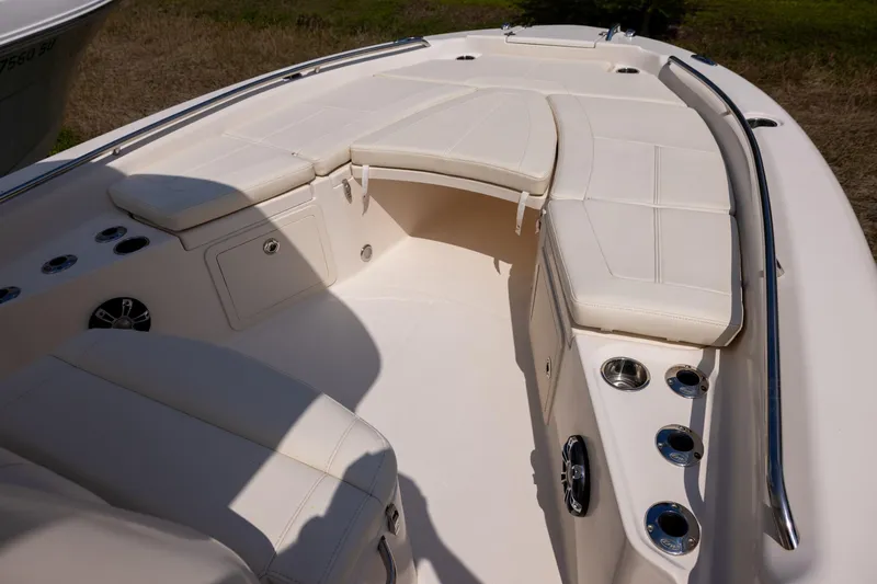 Slide: The Image of 2021 Grady-White 251 Coastal Explorer boat interior with cushioned seating and cup holders. - 11