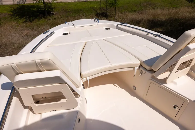 Slide: The Image of 2021 Grady-White 251 Coastal Explorer boat interior with cushioned seating and storage compartments. - 16