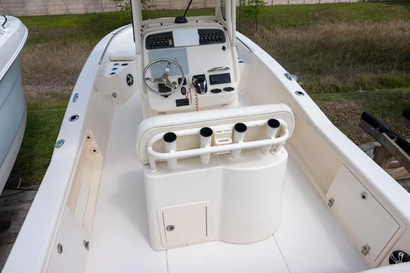 Slide: The Image of 2021 Grady-White 251 Coastal Explorer boat interior with steering console and rod holders. - 4