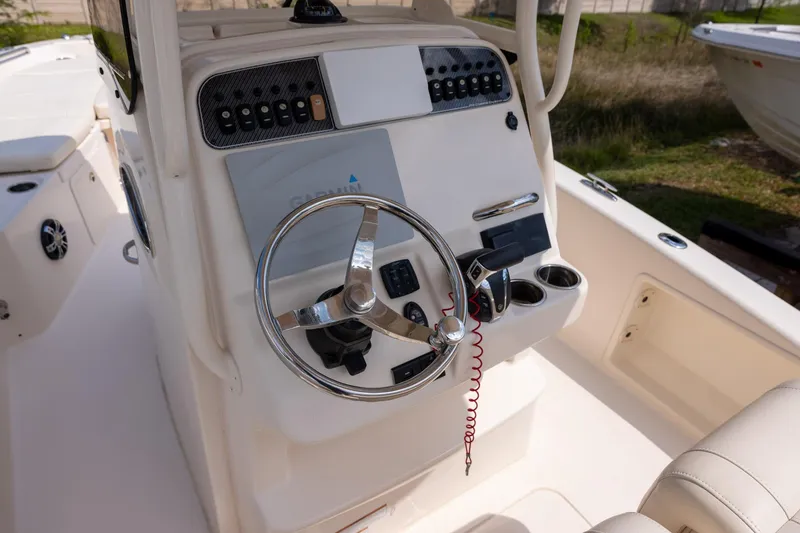 Slide: The Image of 2021 Grady-White 251 Coastal Explorer boat helm with steering wheel and controls. - 6
