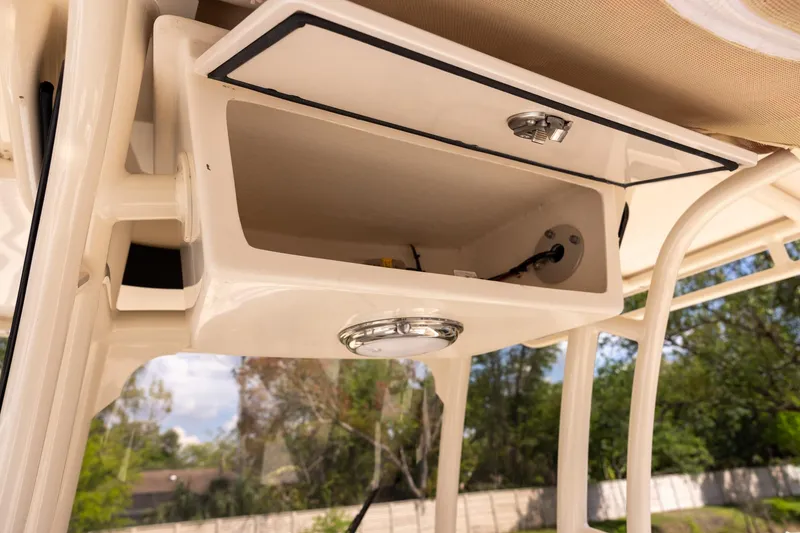 Slide: The Image of 2021 Grady-White 251 Coastal Explorer boat storage compartment with latch and light. - 9