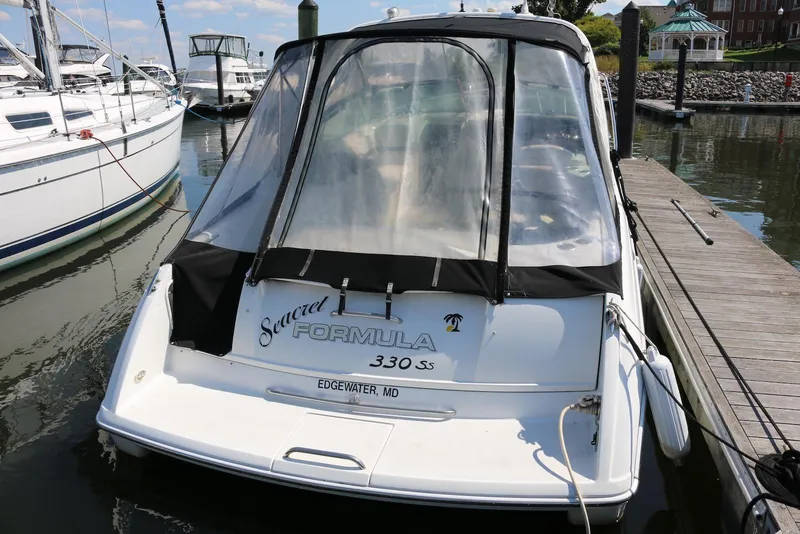 Slide: The Image of 2005 Formula 330 Sun Sport boat docked at marina, rear view. - 11