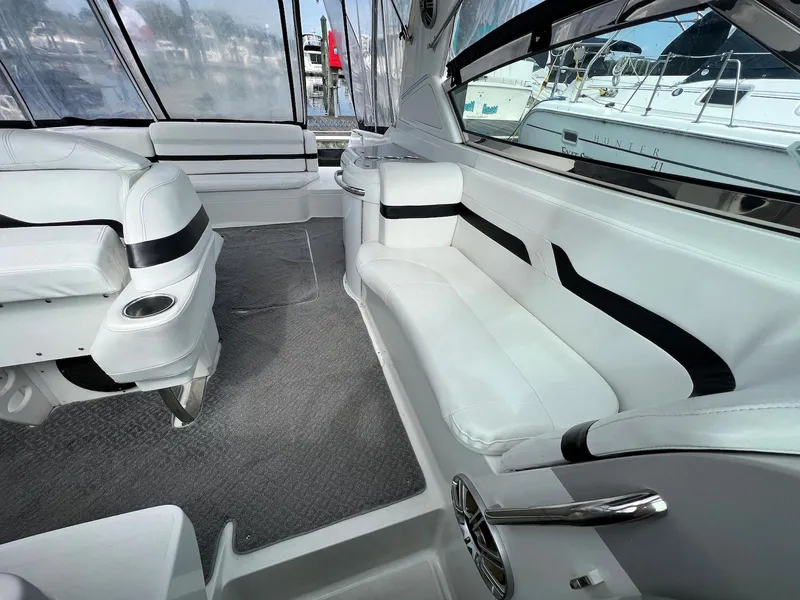 Slide: The Image of 2005 Formula 330 Sun Sport boat interior with white seating and carpeted floor. - 15