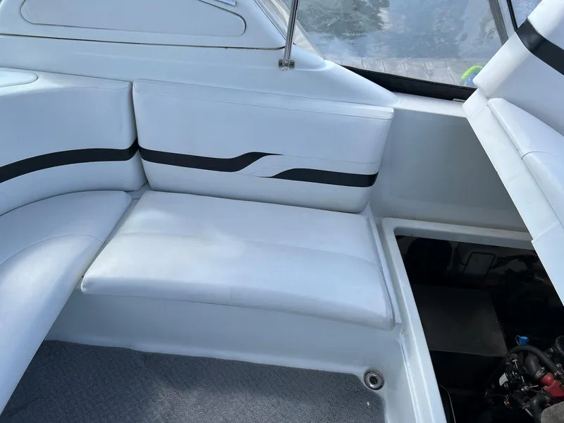 Slide: The Image of 2005 Formula 330 Sun Sport boat interior seating area with white upholstery. - 17