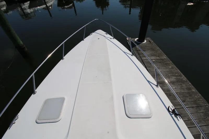 Slide: The Image of 2005 Formula 330 Sun Sport boat bow view at dock. - 19