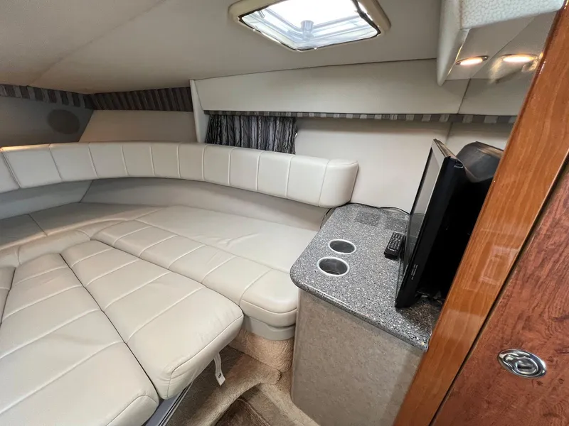 Slide: The Image of 2005 Formula 330 Sun Sport cabin interior with leather seating and TV. - 21