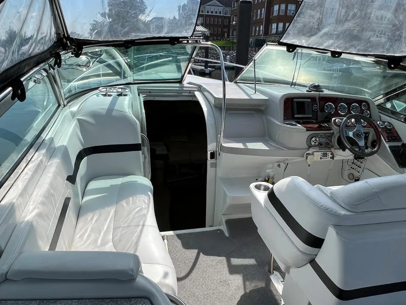 Slide: The Image of 2005 Formula 330 Sun Sport boat interior with white seating and dashboard. - 3