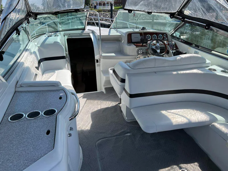 Slide: The Image of 2005 Formula 330 Sun Sport boat interior with white seating and modern dashboard. - 4