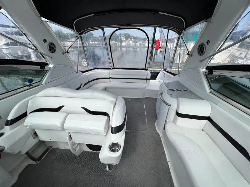 Slide: The Image of Interior of a 2005 Formula 330 Sun Sport boat with white seating and panoramic windows. - 5