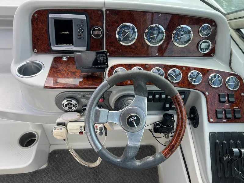 Slide: The Image of 2005 Formula 330 Sun Sport dashboard with Garmin GPS, steering wheel, and control panel. - 9