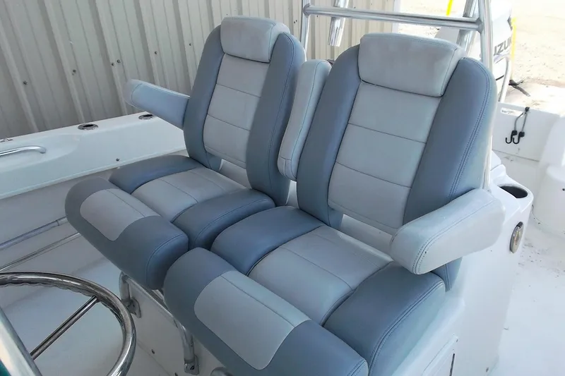 Slide: The Image of 2018 Twin Vee 260 CC SE boat seats, featuring dual cushioned chairs with armrests. - 11