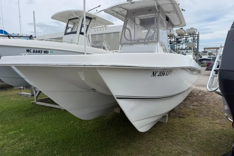 Slide: The Image of 2018 Twin Vee 260 CC SE boat on display, white hull, parked on grass. - 3