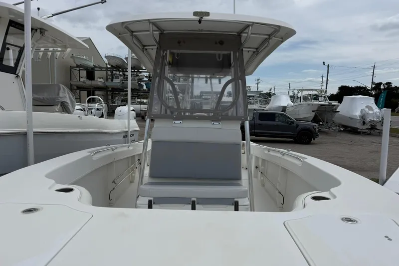 Slide: The Image of 2018 Twin Vee 260 CC SE boat with center console and seating, docked at marina. - 4