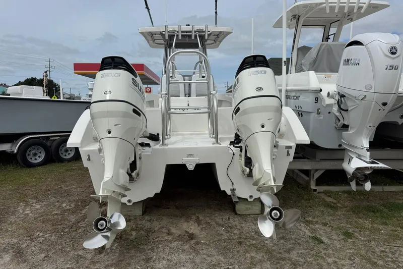 Slide: The Image of 2018 Twin Vee 260 CC SE boat with dual Suzuki 150 outboard motors, displayed outdoors. - 6
