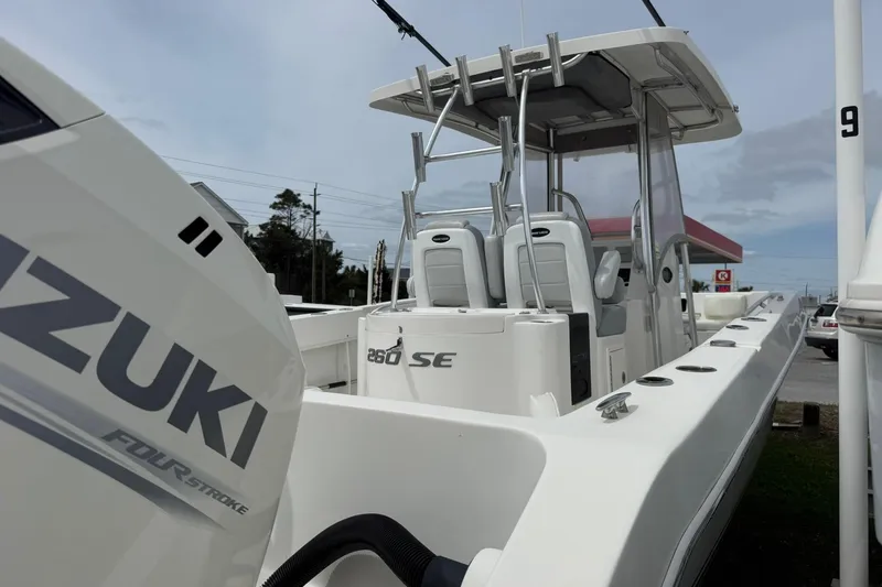 Slide: The Image of 2018 Twin Vee 260 CC SE boat with Suzuki four-stroke engine, docked outdoors. - 7