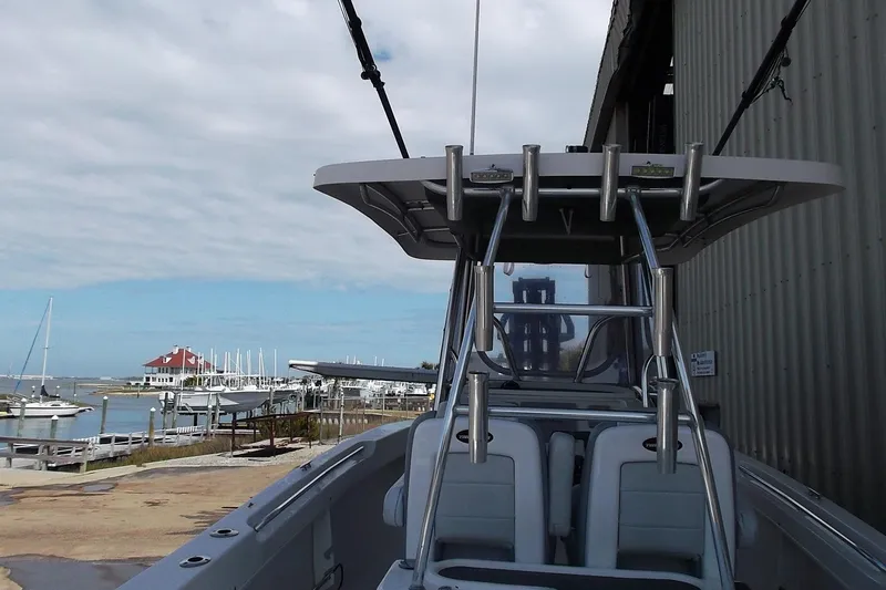 Slide: The Image of 2018 Twin Vee 260 CC SE boat docked near marina with clear sky. - 8