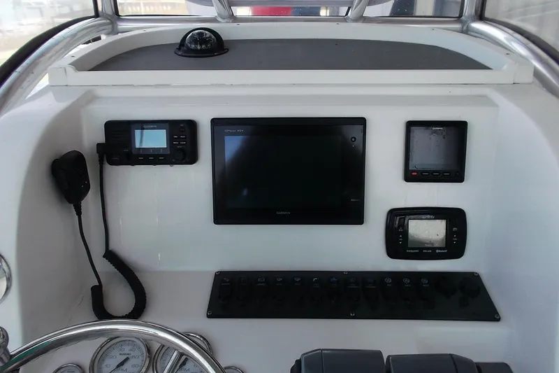 Slide: The Image of 2018 Twin Vee 260 CC SE boat dashboard with navigation and communication equipment. - 9