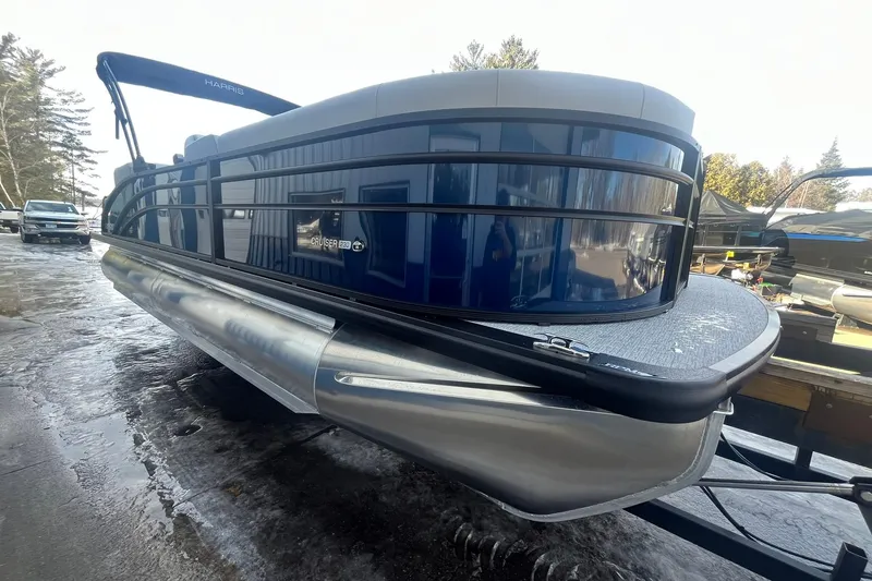 Slide: The Image of 2026 Harris Cruiser 230 CWDH pontoon boat on trailer, sleek design, blue exterior. - 10